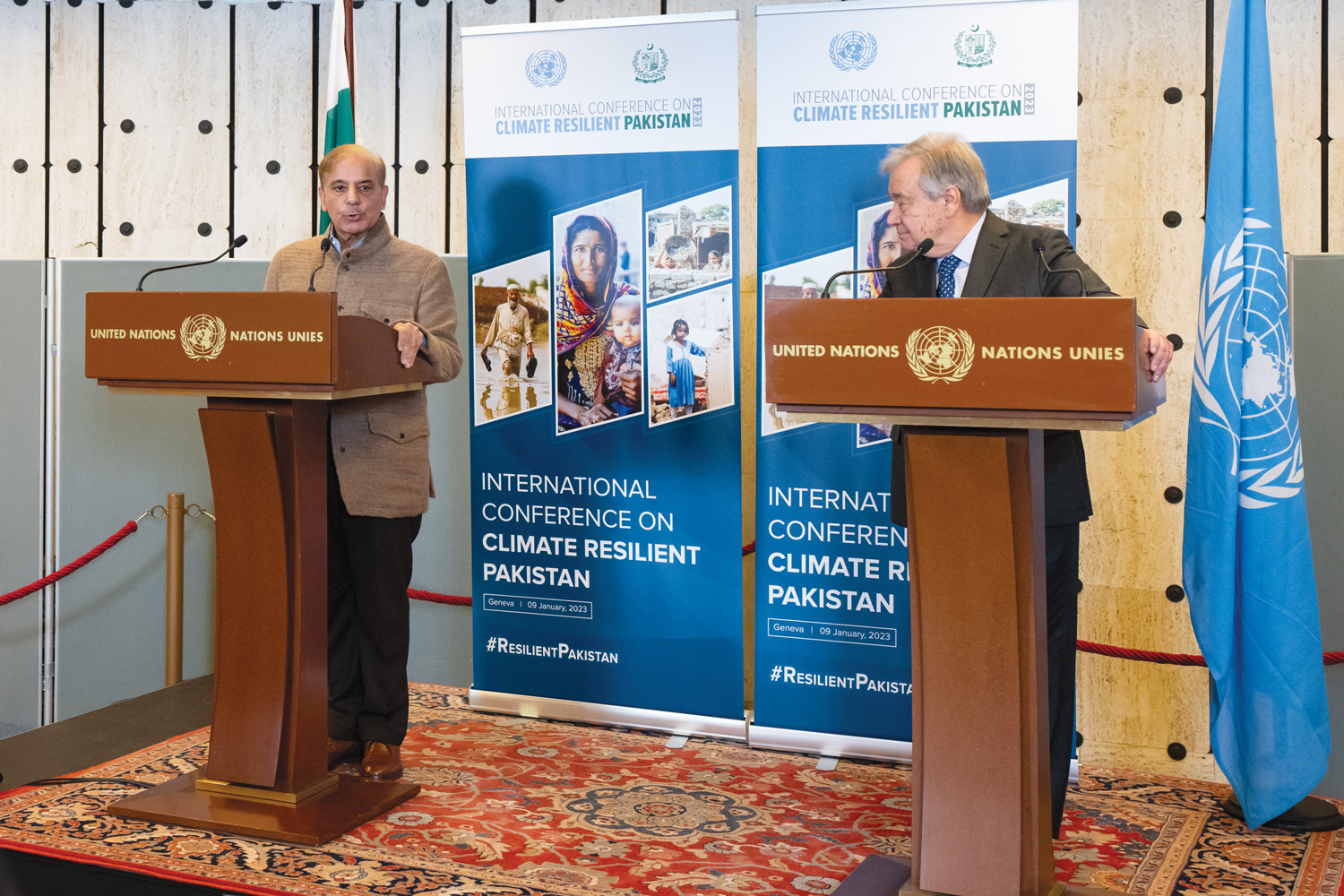 Photo showing the Secretary-General of the United Nations, António Guterres and the Prime Minister of the Islamic Republic of Pakistan, Muhammad Shehbaz Sharif standing behind two rostrums next to each other. Behind Mr. Guterres is a United Nations flag. The flag of the Islamic Republic of Pakistan is standing behind the Prime Minister. Two roll-up banners are placed behind them displaying information about the International Conference on Climate Resilient Pakistan. 