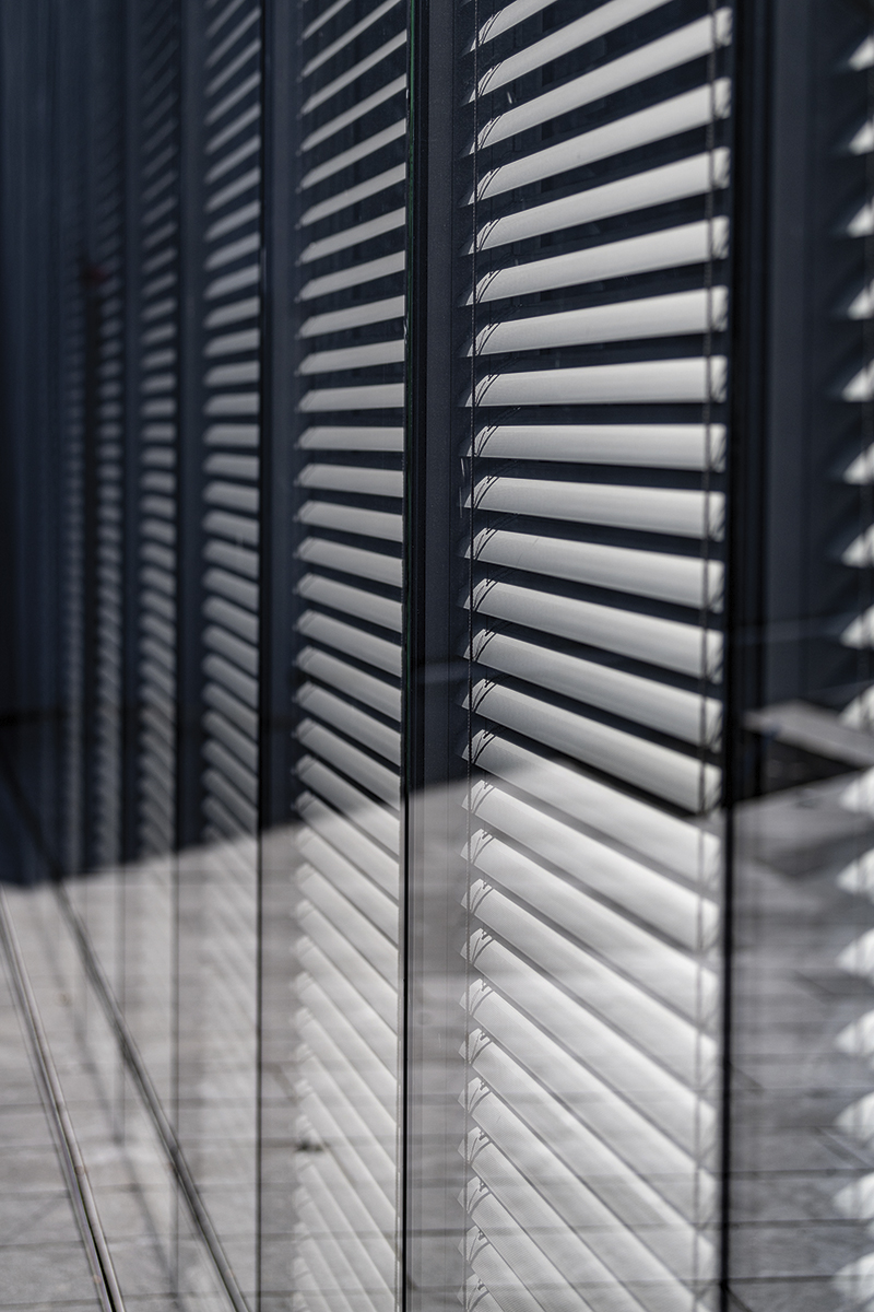 Dark gray window blinds on the new building.